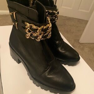 Chic black combat boots with gold chain